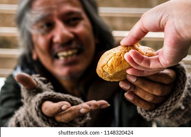 People Give Bread Or Sharing Food To Poor And Homeless Man To Help His Hungry For Charity