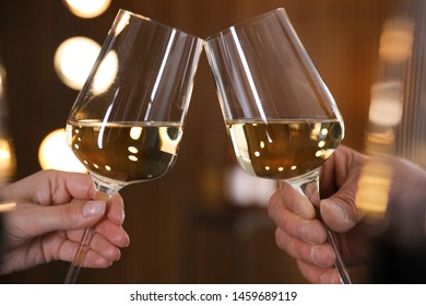 People with glasses of wine on blurred background, closeup