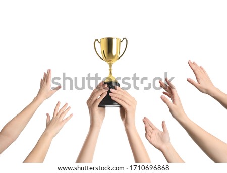 People with golden trophy cup on white background, closeup