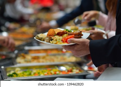 people group catering buffet food indoor in luxury restaurant with meat colorful fruits  and vegetables - Powered by Shutterstock
