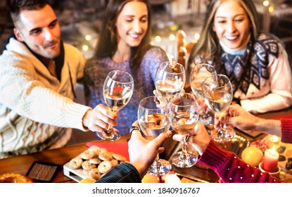 People Group Celebrating Christmas Toasting Champagne Wine At Home Dinner Party - Winter Holiday Concept With Young Friends Enjoying Time And Having Fun Together - Warm Filter With Focus Lower Glass