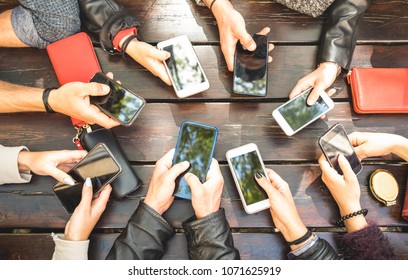 People group having addicted fun together using smartphones - Detail of hands sharing content on social network with mobile smart phones - Technology concept with millennials online with cellphones  - Shutterstock ID 1071625919