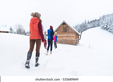 People Group Near Wooden Country House Winter Snow Resort Cottage Friends On Vacation