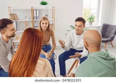 People in group therapy having an interesting discussion. Happy male and female patients talking in a circle during a meeting. Business teammates listening to an experienced coach sharing his advice - Powered by Shutterstock