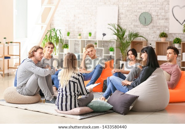 People at group therapy\
session
