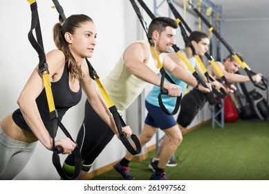 People At Gym Doing Elastic Rope Exercises At Cross Fit Room