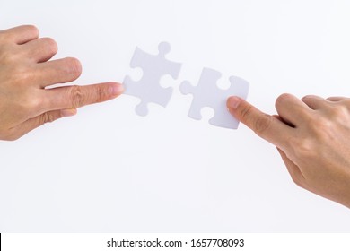 People hand connect two couple puzzle pieces. - Shutterstock ID 1657708093