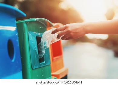 people hand holding garbage bottle plastic putting into recycle bin for cleaning - Shutterstock ID 1416504641