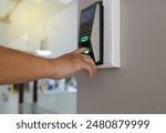 People hand push finger down on the electronic control machine to access the door. Soft and Selective focus