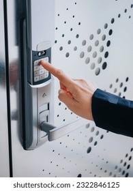 People hand touch on Keypad Digital door lock Security code Modern metal pattern