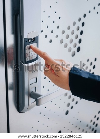 People hand touch on Keypad Digital door lock Security code Modern metal pattern