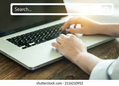 People hand using laptop or computer searching for information with search box icon.