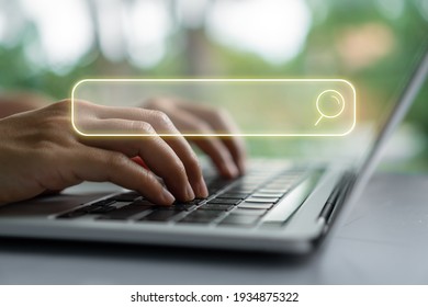 People hand using laptop or computor searching for information in internet online society web with search box icon and copyspace. - Shutterstock ID 1934875322