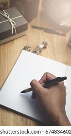 People hand write on empty paper by pen 