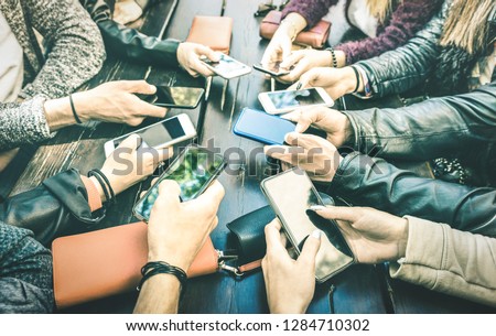 People hands having addicted fun together using smartphone - Millenial sharing content on social media network with mobile smart phones - Technology concept with millennials online on cellphone device