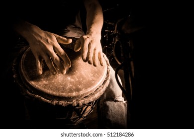 People hands playing music at djembe drums, France