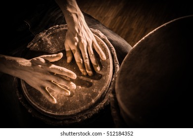 People hands playing music at djembe drums, France