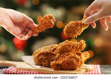 People hands taking the fried chicken wings by hands,Christmas night dinner. - Shutterstock ID 2231766817