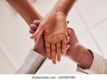 People, hands together and unity below in trust for community, agreement or teamwork at the office. Group piling hand for team collaboration, support or coordination for corporate goals in solidarity - Shutterstock ID 2259367585
