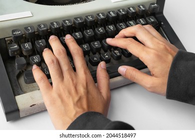 People Hands Typing An Old Thai Traditional Typewriter. Classic Vintage Antique Manual Typing Machine Isolated On White Background. 19th Century Item. Lifestyle