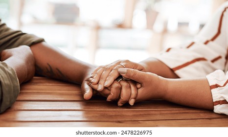 People, hands or wood desk with empathy for relationship, love or trust in house. Couple, together or solidarity in home with support or kindness, helping others with comfort or prayer in living room - Powered by Shutterstock