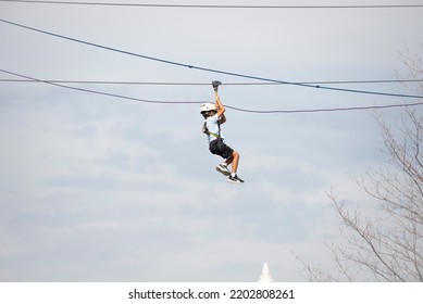 People hanging on a rope in midair