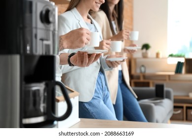 People Having Coffee Break In Office