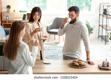 People Having Coffee Break In Office