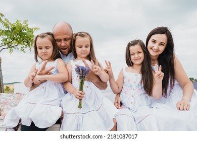People are having fun.
The concept of a friendly family.Cool photo session in a field of golden wheat.Cheerful emotional family portrait. - Shutterstock ID 2181087017
