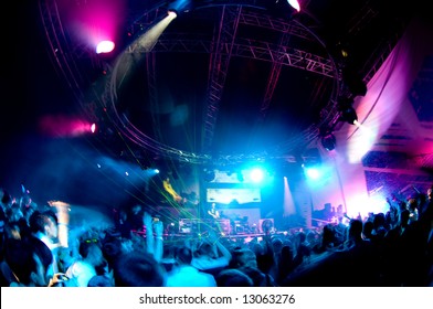 People having fun at the concert, laser show and music - Shutterstock ID 13063276