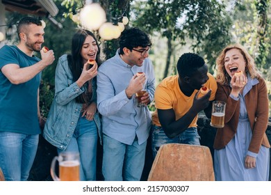 People Having Fun - Happy Friends Playing With Food - Glamping Party With Small Pizzas And Beer - Holiday Concept