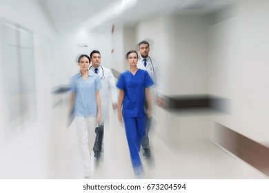 Menschen-, Gesundheits- und Medizin-Konzept - Gruppe der im Krankenhaus spazierenden Ärzte (Bewegungsunschärfe)