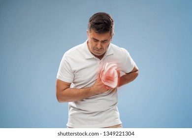people, healthcare and health problem concept - unhappy middle-aged man having heart attack or heartache over blue background