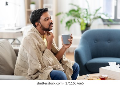 People, Healthcare And Problem Concept - Sick Man With Cup Of Tea Touching His Sore Throat At Home