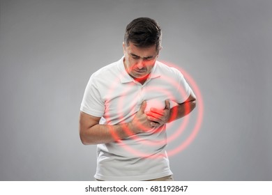 People, Healthcare And Problem Concept - Unhappy Man Suffering From Heart Ache Over Gray Background