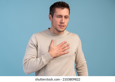 People, Healthcare And Problem Concept. Waist Up Of Caucasian Man Suffering From Heart Ache Over Blue Background 