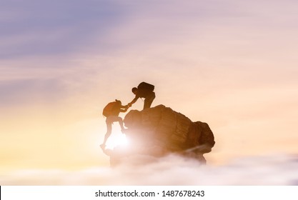 People Helping Each Other Hike Up A Mountain At Sunrise. Giving A Helping Hand, And Active Fit Lifestyle Concept.Asia Couple Hiking Help Each Other.