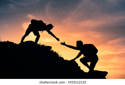 People helping each other up a mountain. Helping hand and teamwork concept. 