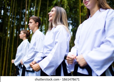 People High Kicks During Training Of Taekwondo Outdoors Bamboo Background