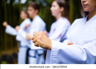 People High Kicks During Training Of Taekwondo Outdoors Bamboo Background