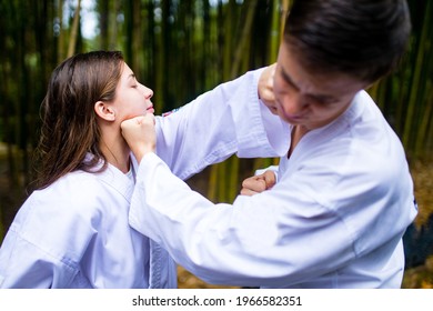 People High Kicks During Training Of Taekwondo Outdoors Bamboo Background