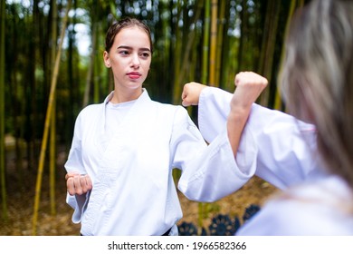 People High Kicks During Training Of Taekwondo Outdoors Bamboo Background