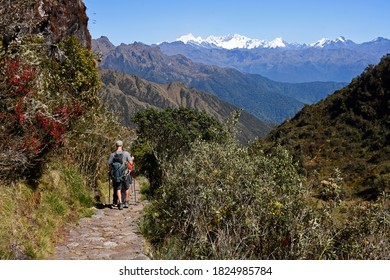 People hiking in the Andes in Inka Trail enroute to Macchu Picchu passing through some of the ruins.