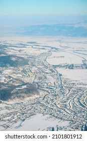 People Hiking In Beautiful Winter Mountains For Winter Sport Activity Snow Mountain Hills. Visit Piatra Craiului National Park To See Its Iconic Rocky Monolith Winter Hiking. Zarnesti City Background