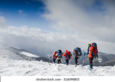 people hiking in beautiful winter mountains