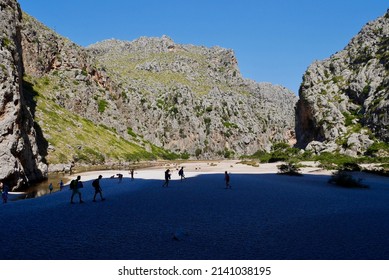 People hiking in canyon of Torrent de Pareis, in the hinterland of Cala Sa Calobra. Majorca, Spain. High quality photo