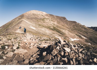People hiking up the steep section of Quandary Peak in Colorado.  - Shutterstock ID 1130666261