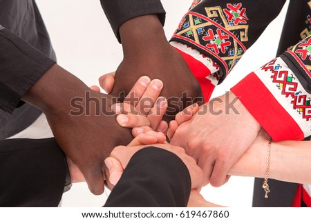 People hold hands. The concept of uniting different people.
