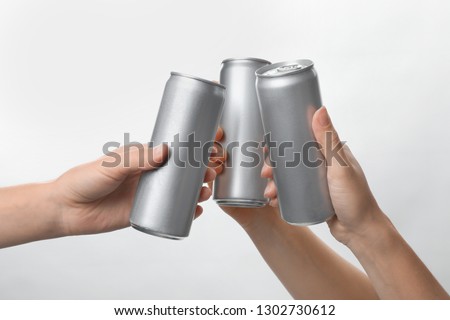 People holding aluminum cans on white background, closeup. Space for design