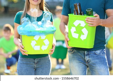 People Holding Containers With Garbage Outdoors. Concept Of Recycling